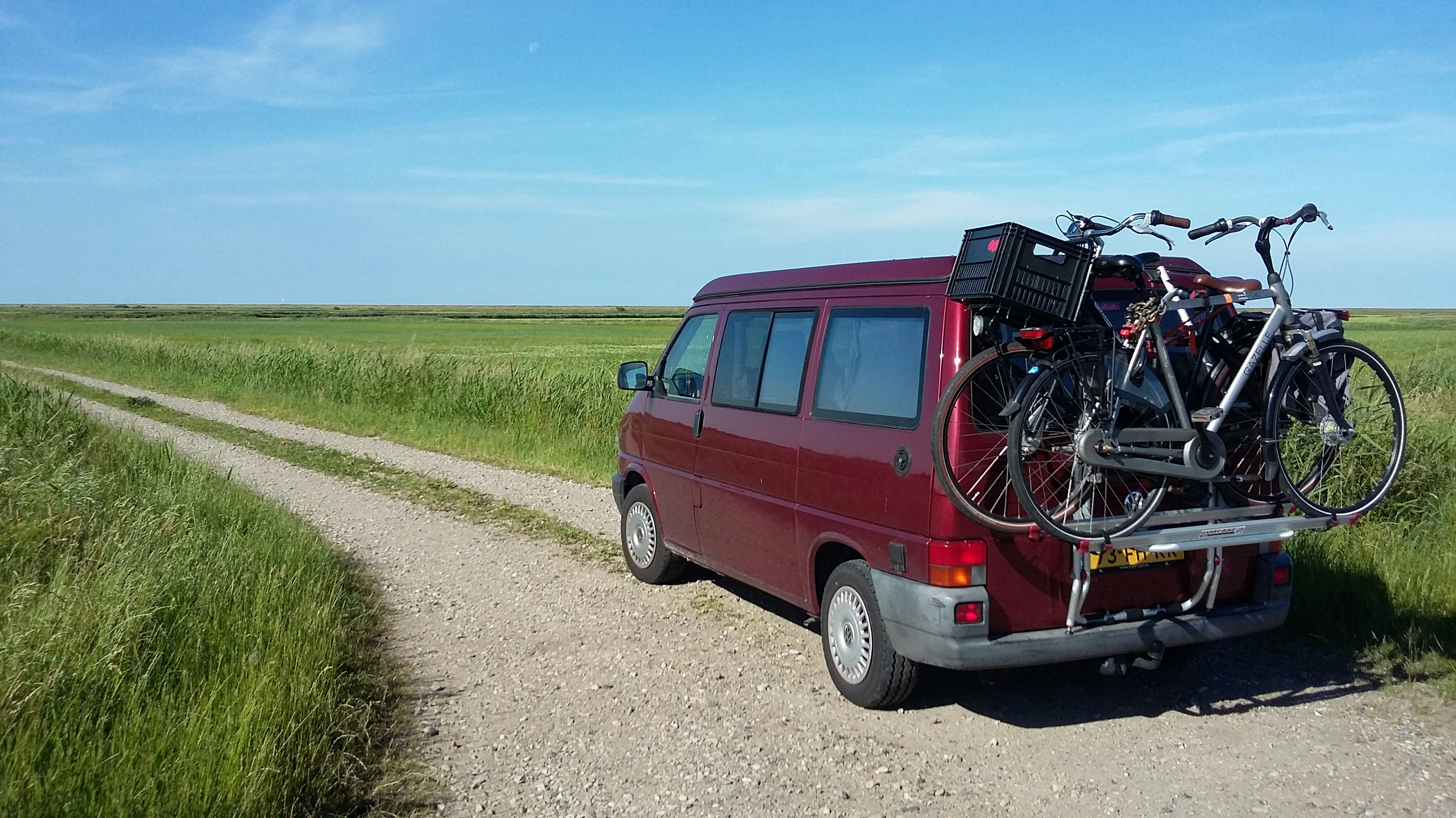 red suv on dirt road during daytime