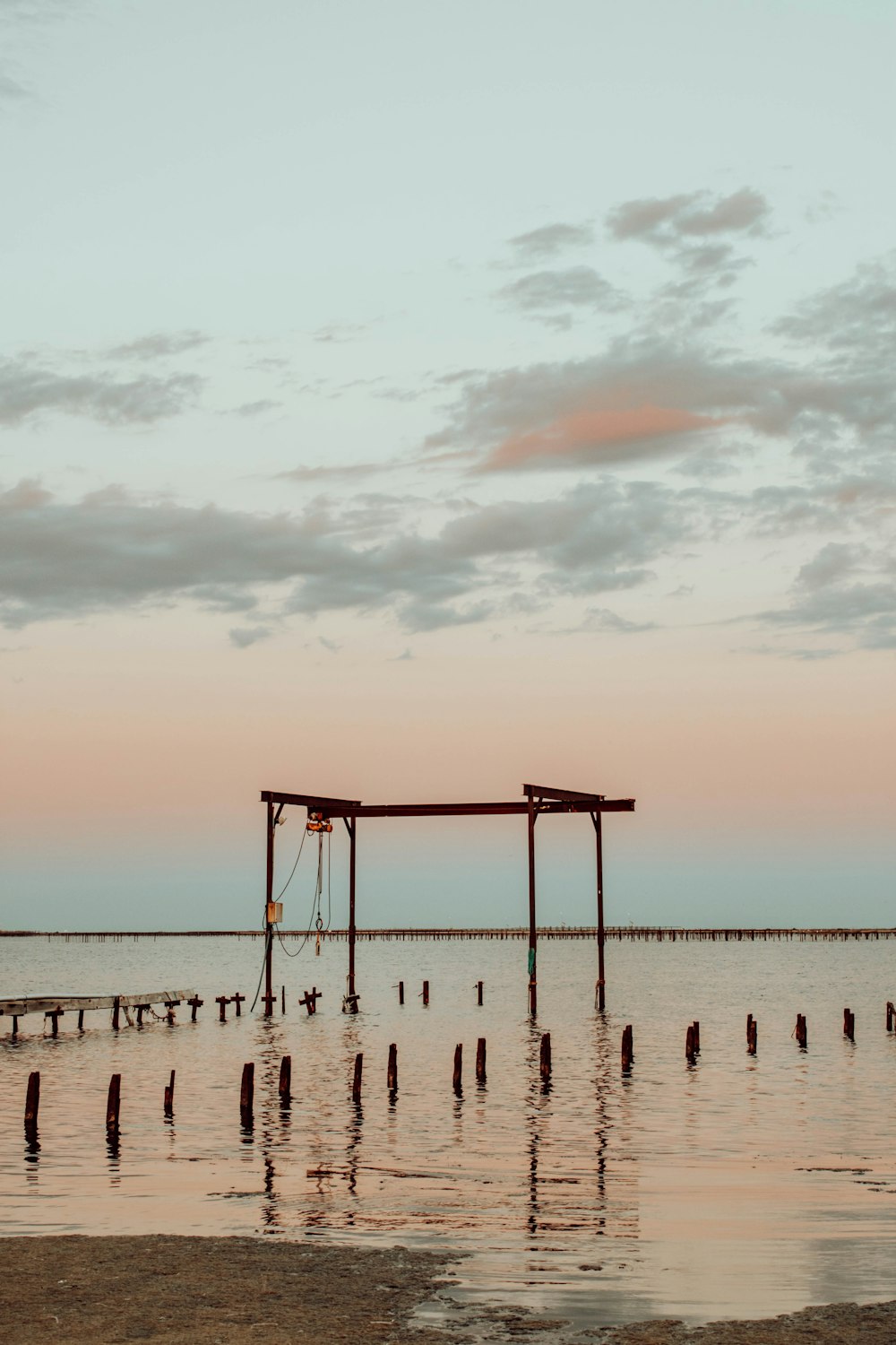 brown wooden lifeguard tower on beach during daytime