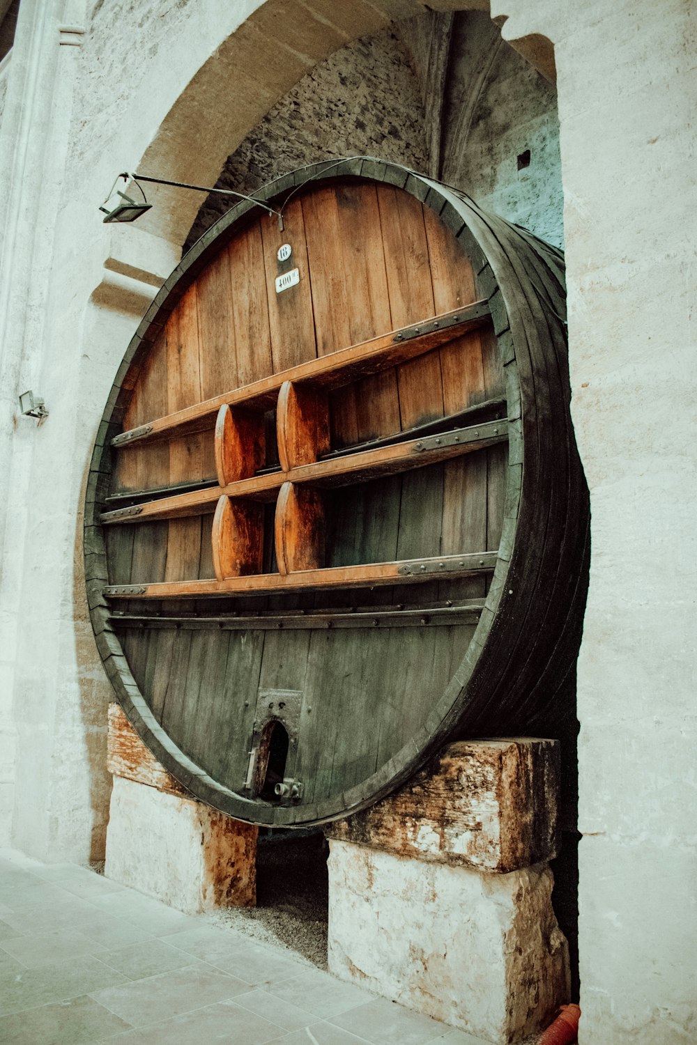 brown wooden round door on gray concrete wall