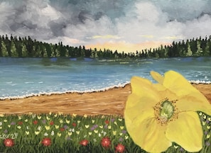A vibrant landscape painting depicting a large yellow flower in the foreground, bordered by a field of wildflowers in various colors. A sandy beach separates the flowers from a calm lake, reflecting the sky above. Dense, green trees line the horizon under a sky filled with thick, dramatic clouds and hints of a sunset.