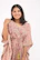 A smiling customer wearing a handmade garment made from sustainable fabric.