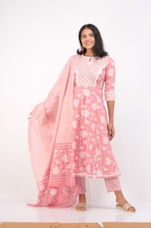 Happy customer wearing a custom-tailored kurti, smiling in a sunlit room.