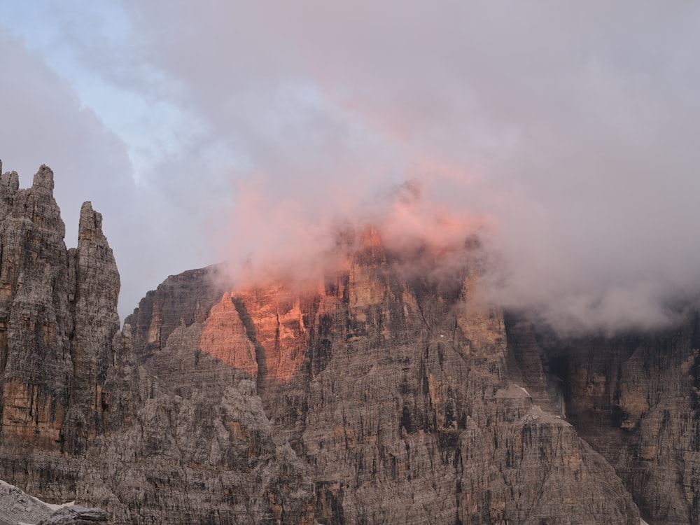 brown rocky mountain with white clouds