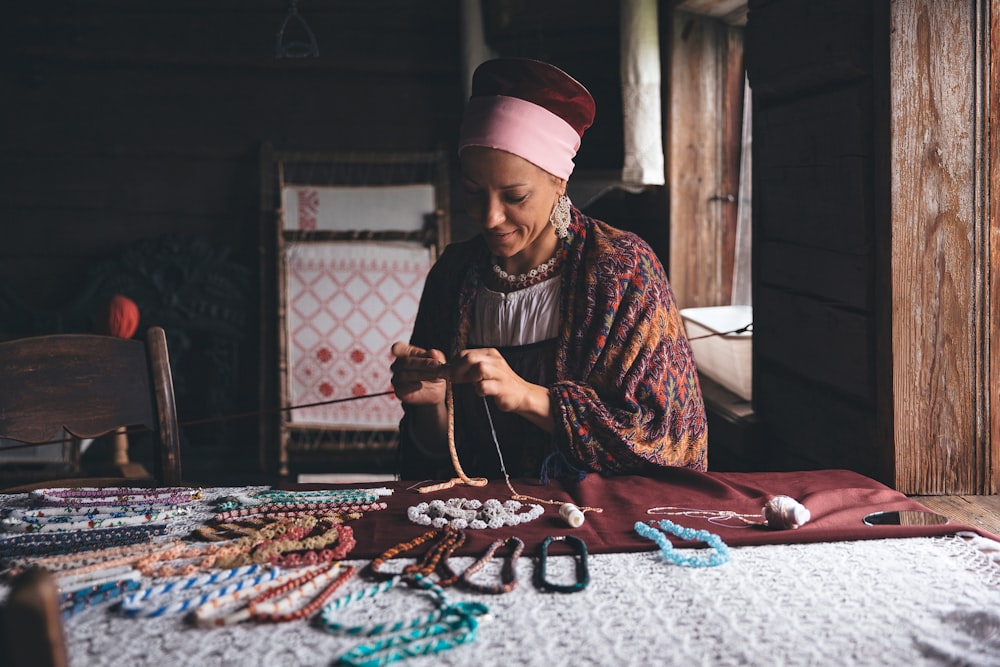 woman in red and brown hijab sitting on floor