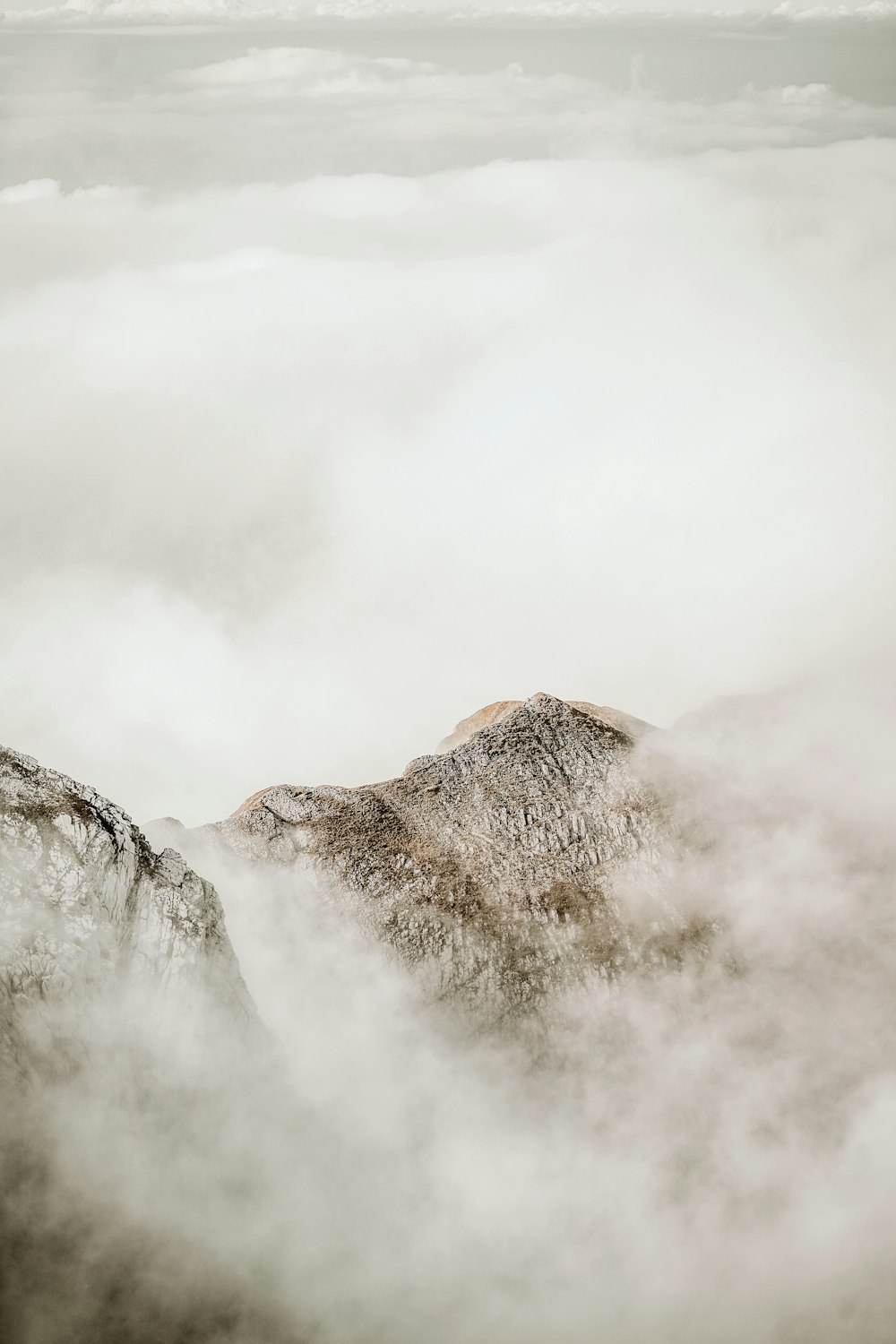 Brauner Berg mit weißen Wolken bedeckt