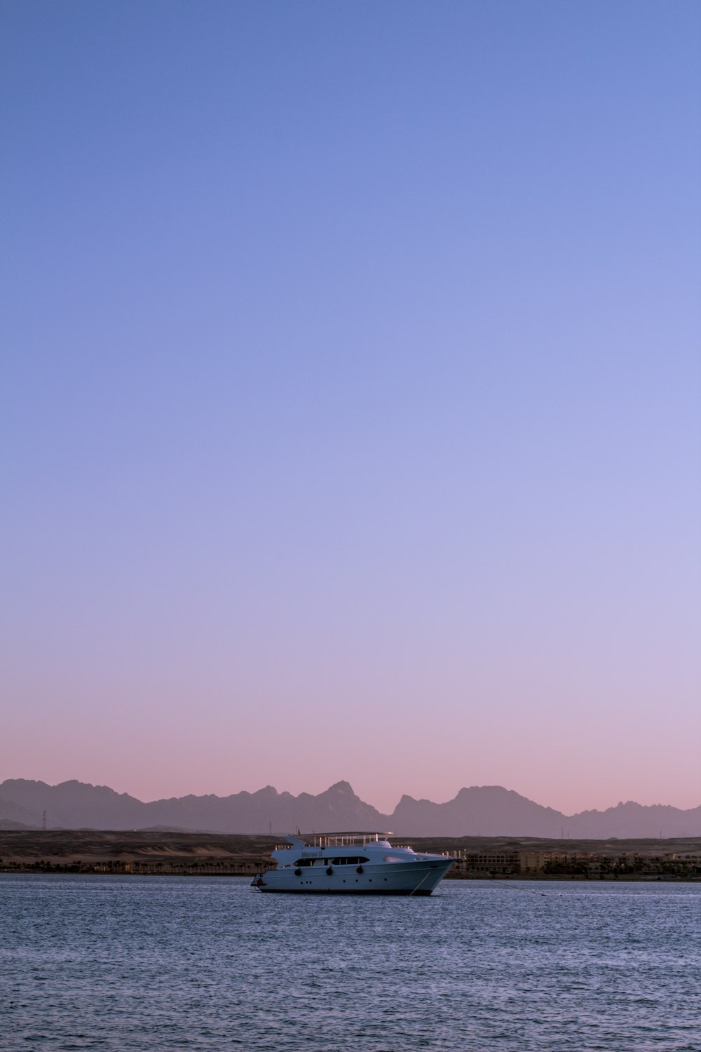 white and blue boat on sea during daytime