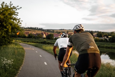 man in brown t-shirt riding on bicycle on road during daytime