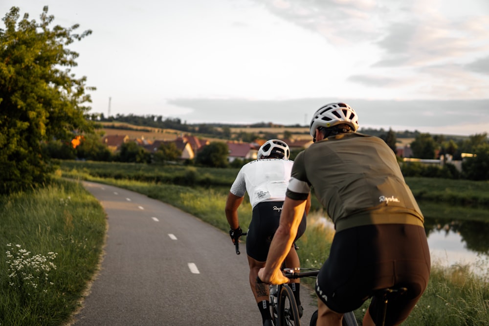 man in brown t-shirt riding on bicycle on road during daytime