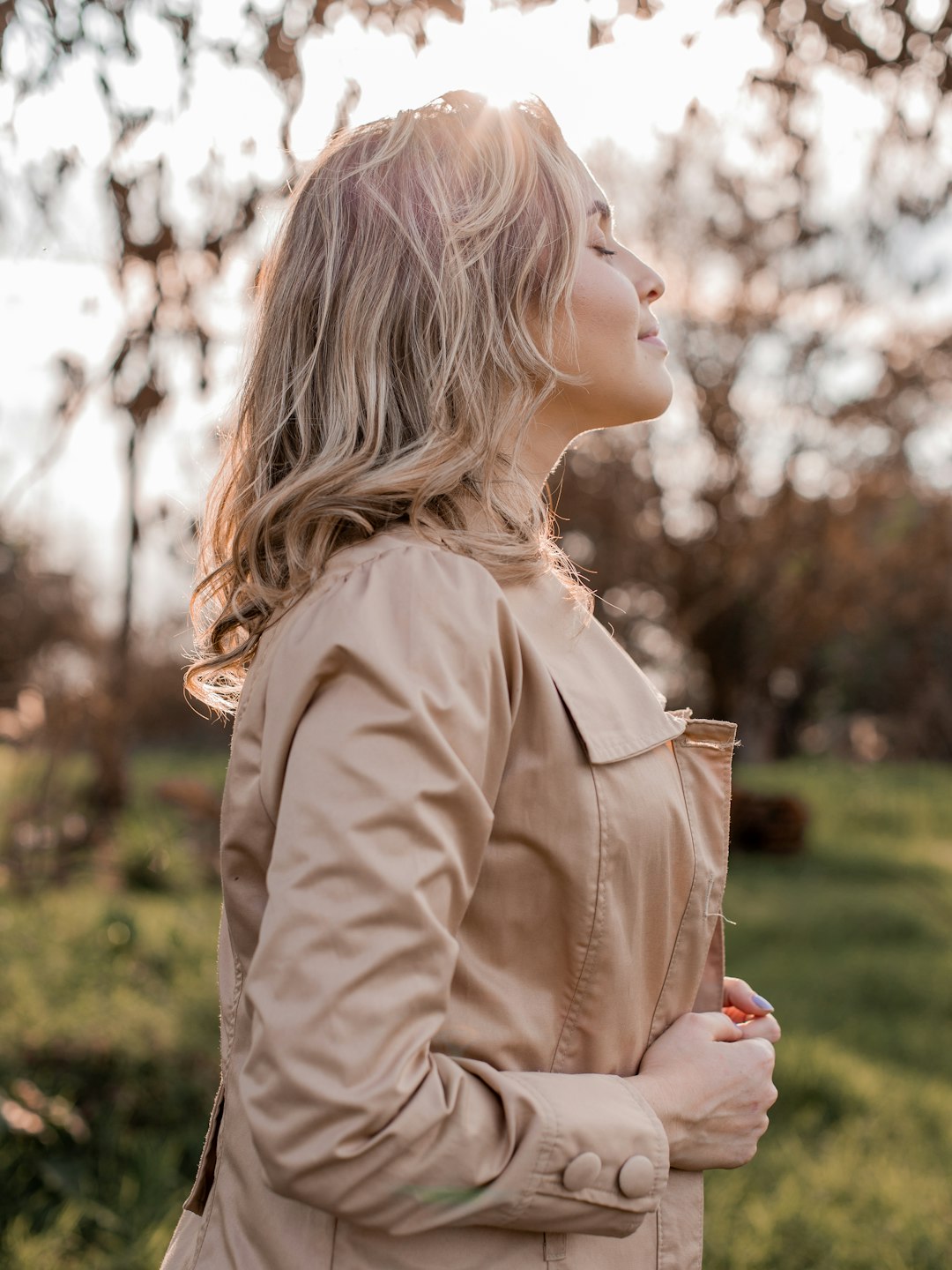 woman in brown coat looking down