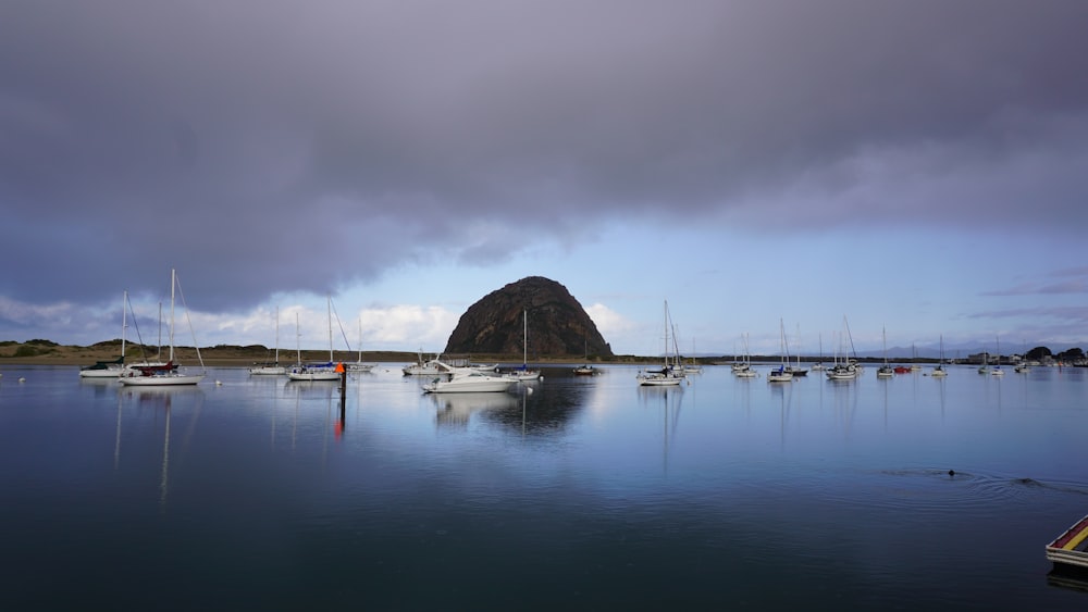 boat on sea near mountain during daytime