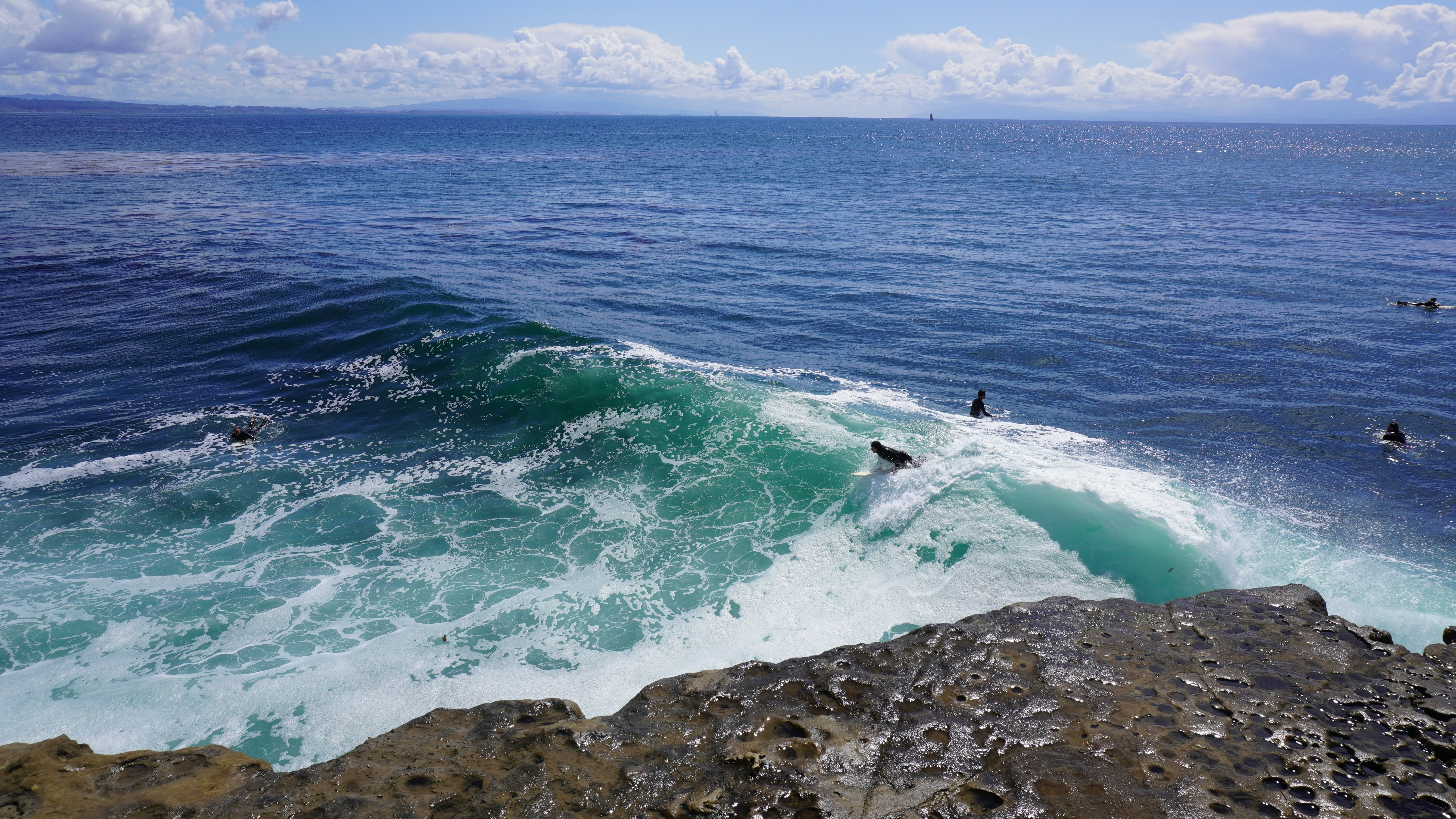 person surfing on sea waves during daytime