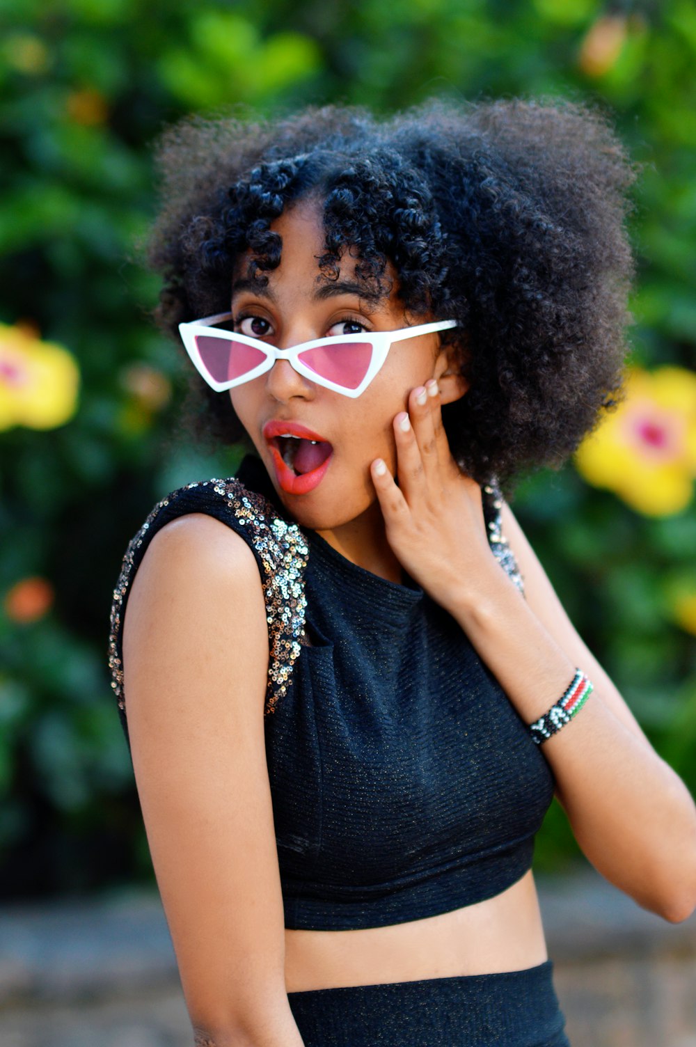 woman in black tank top wearing white framed sunglasses