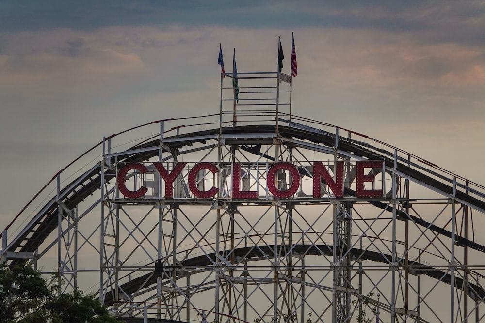a roller coaster with a sign that says cyclone