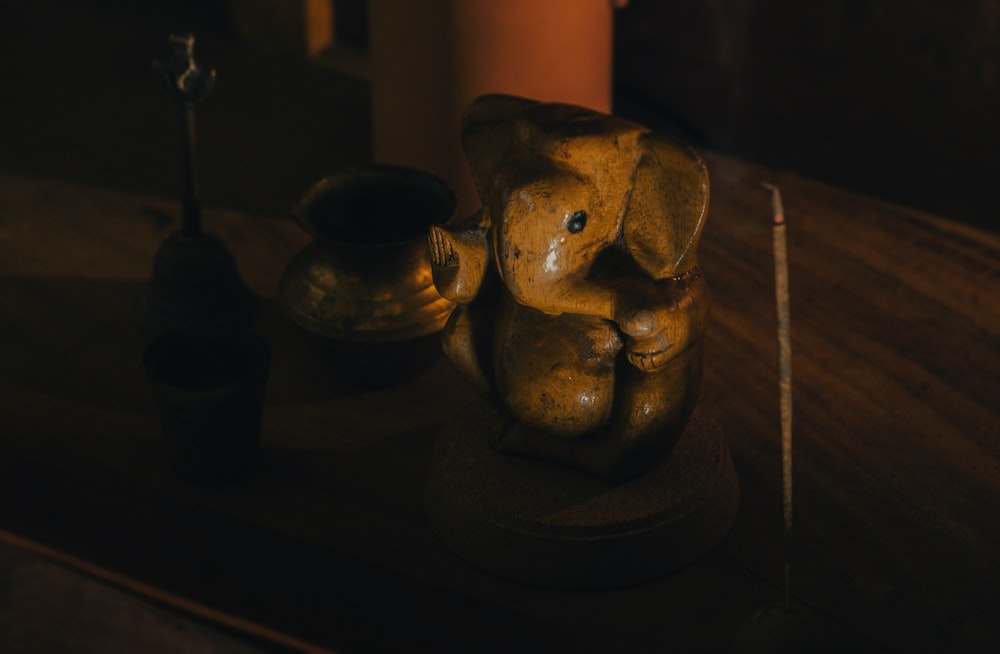 brown ceramic elephant figurine on brown wooden table
