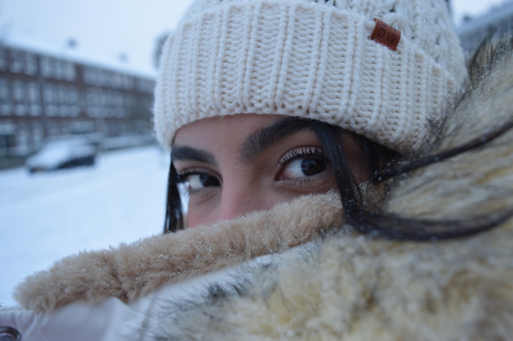 person wearing white knit cap and black framed eyeglasses