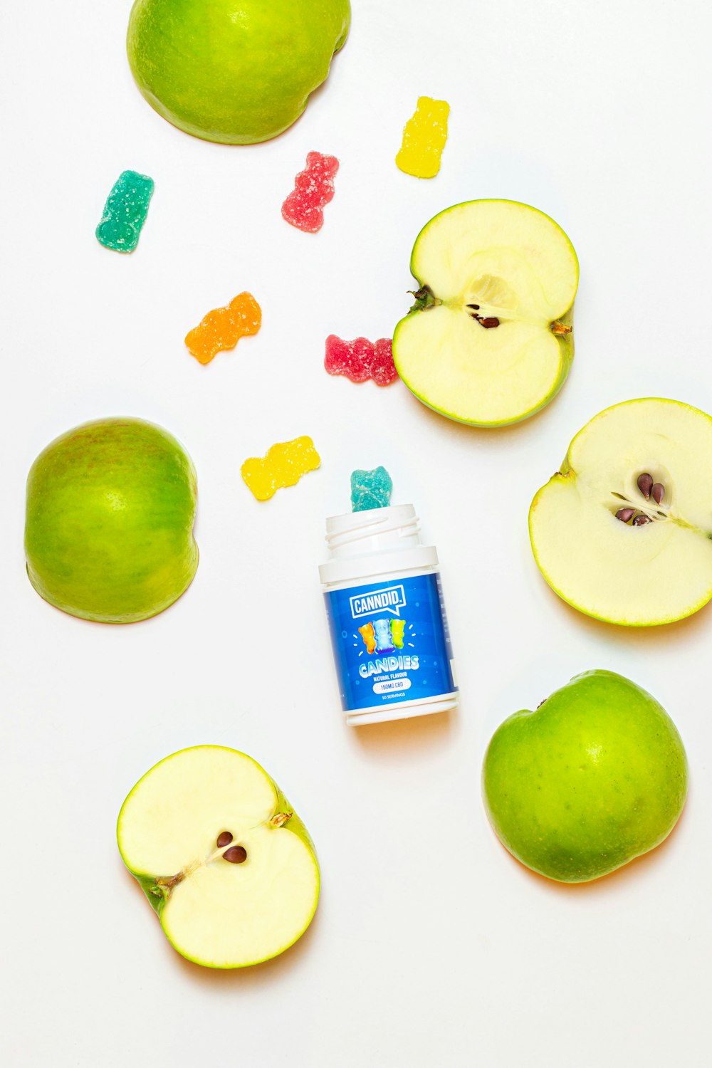 white and blue plastic bottle beside green apple