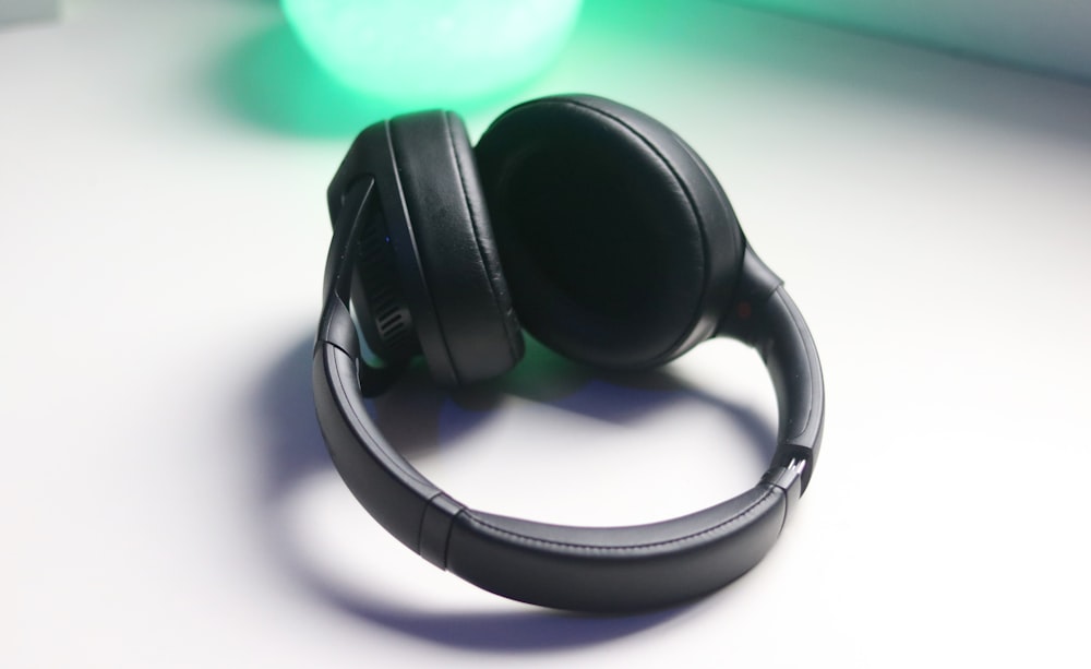 black and gray headphones on white table