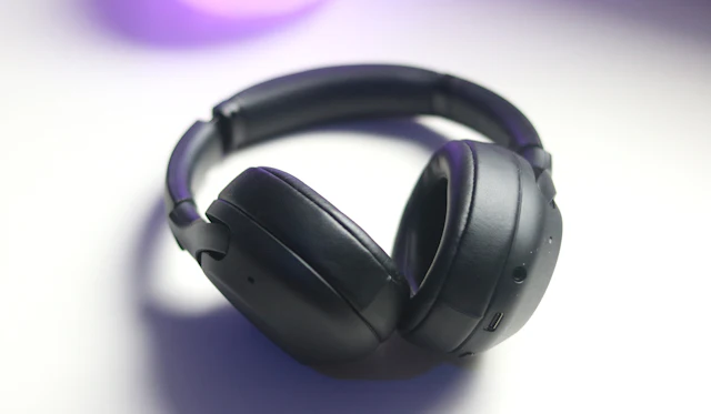 Black headphones on a white surface.