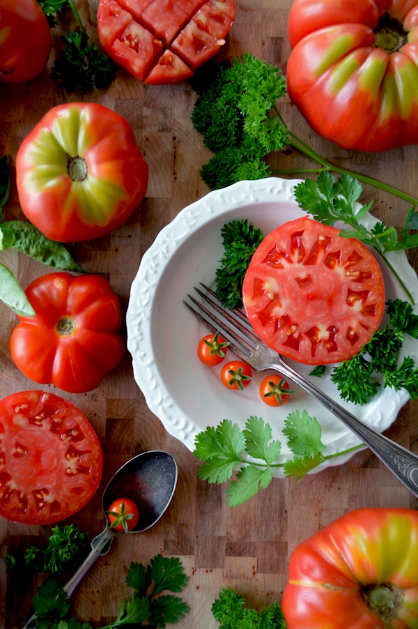 Sliced tomato on white ceramic plate