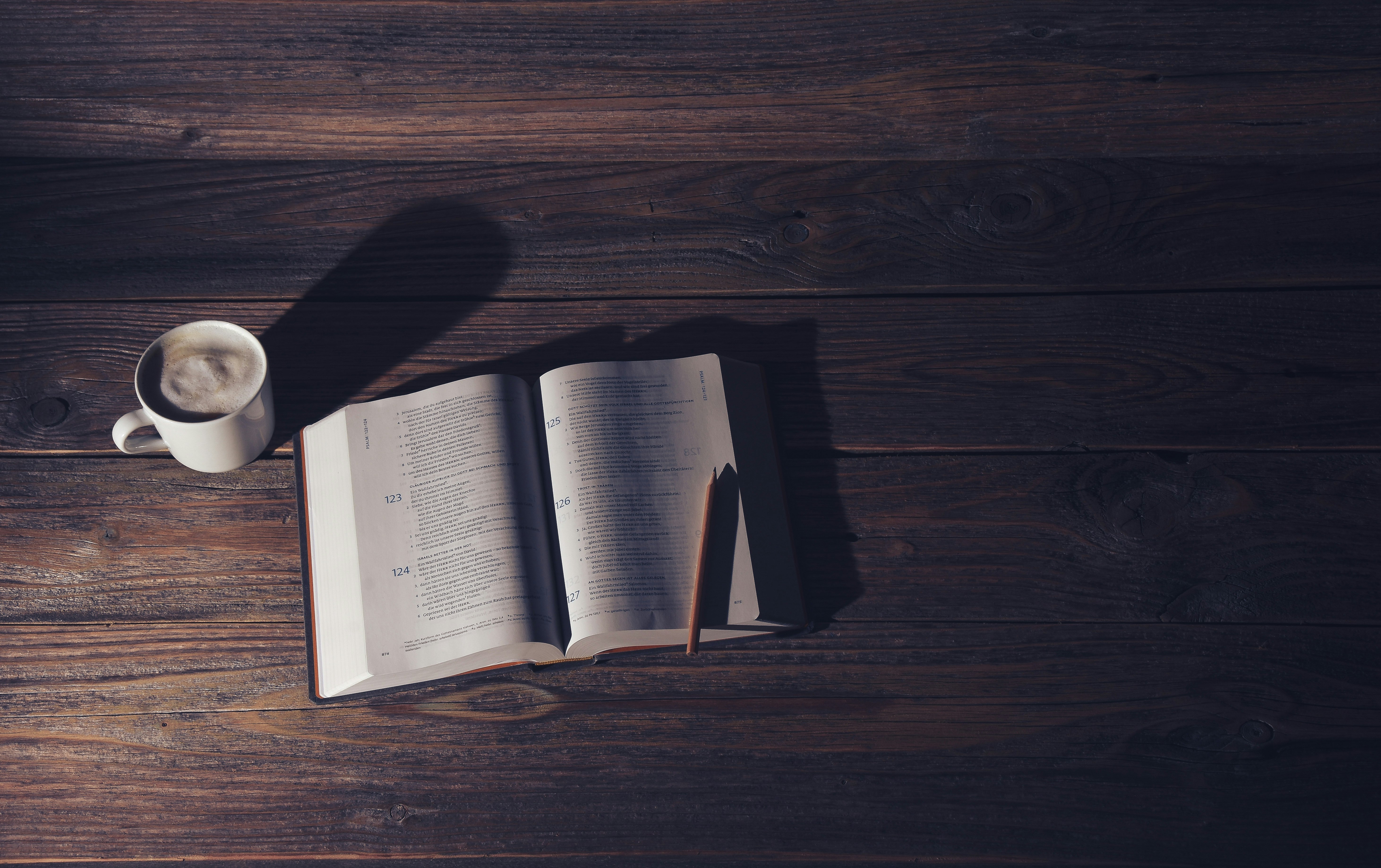 white book page on brown wooden table