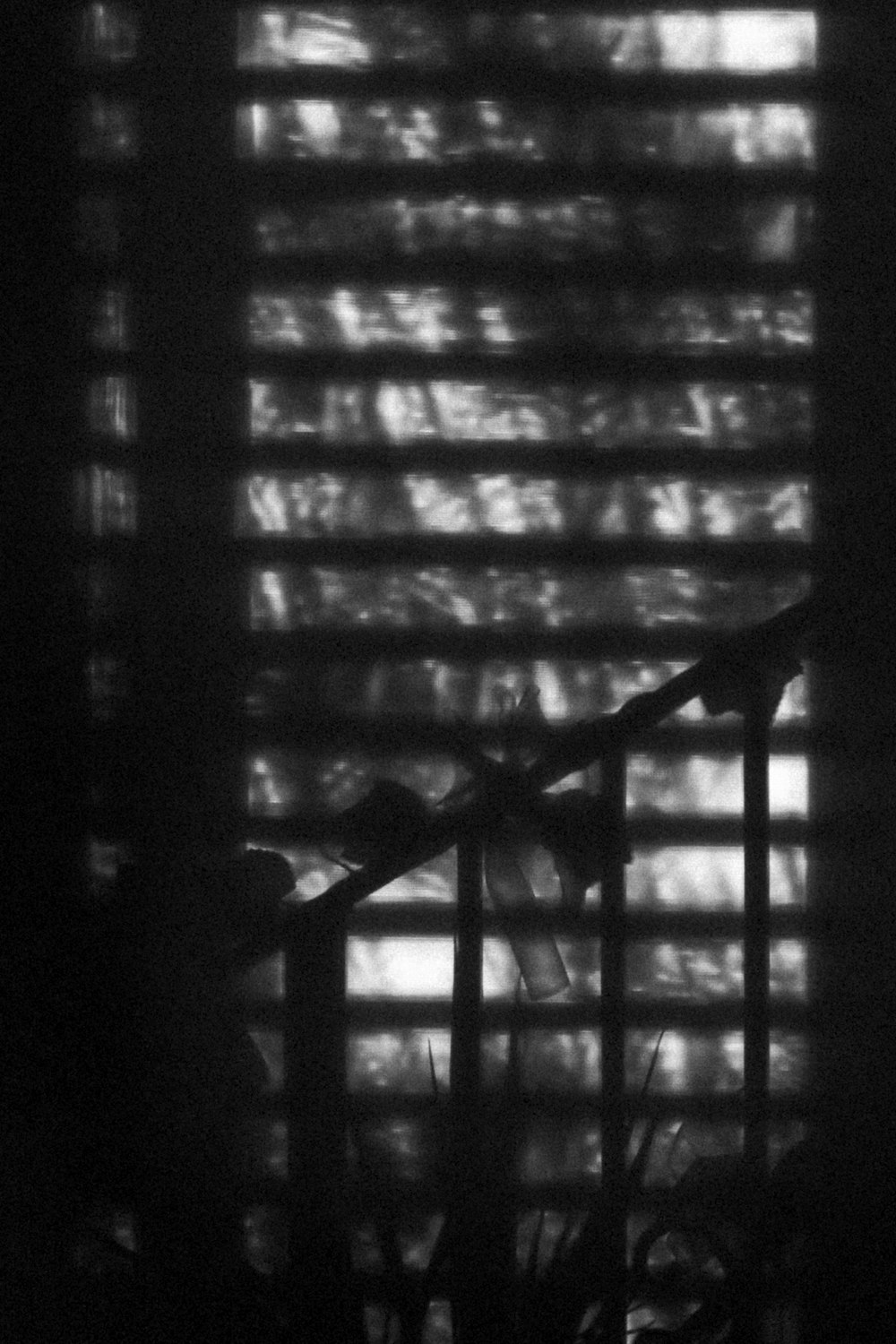 black metal window grill in grayscale photography