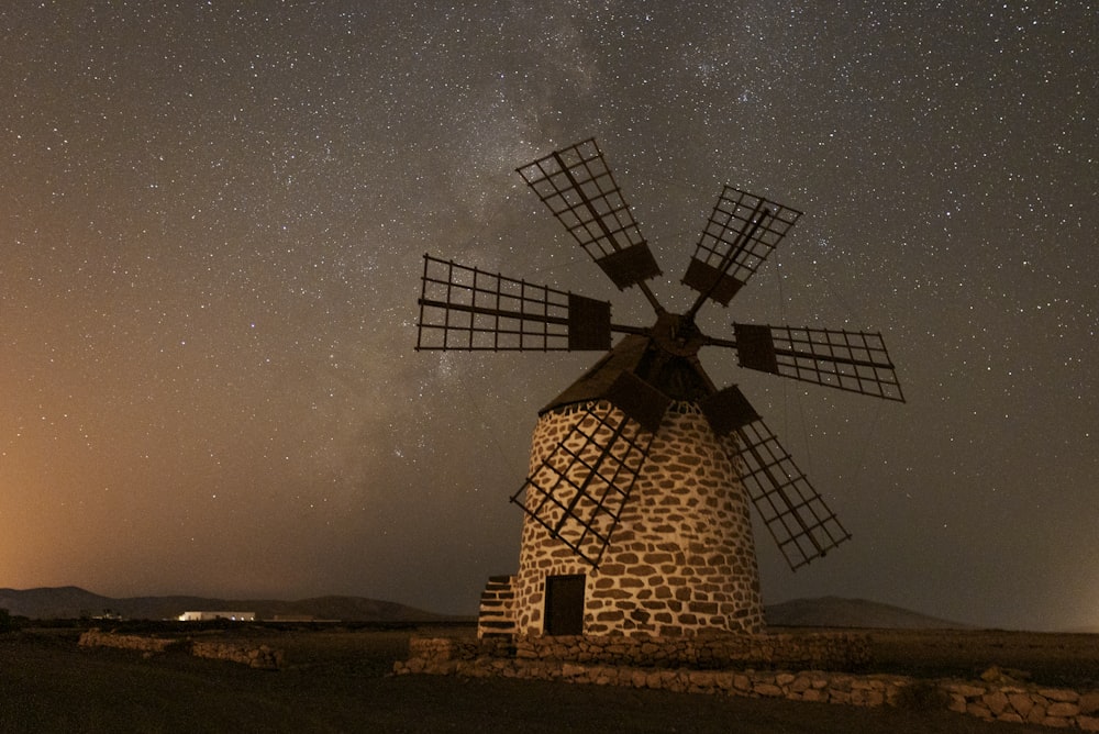 brown and black windmill under gray sky