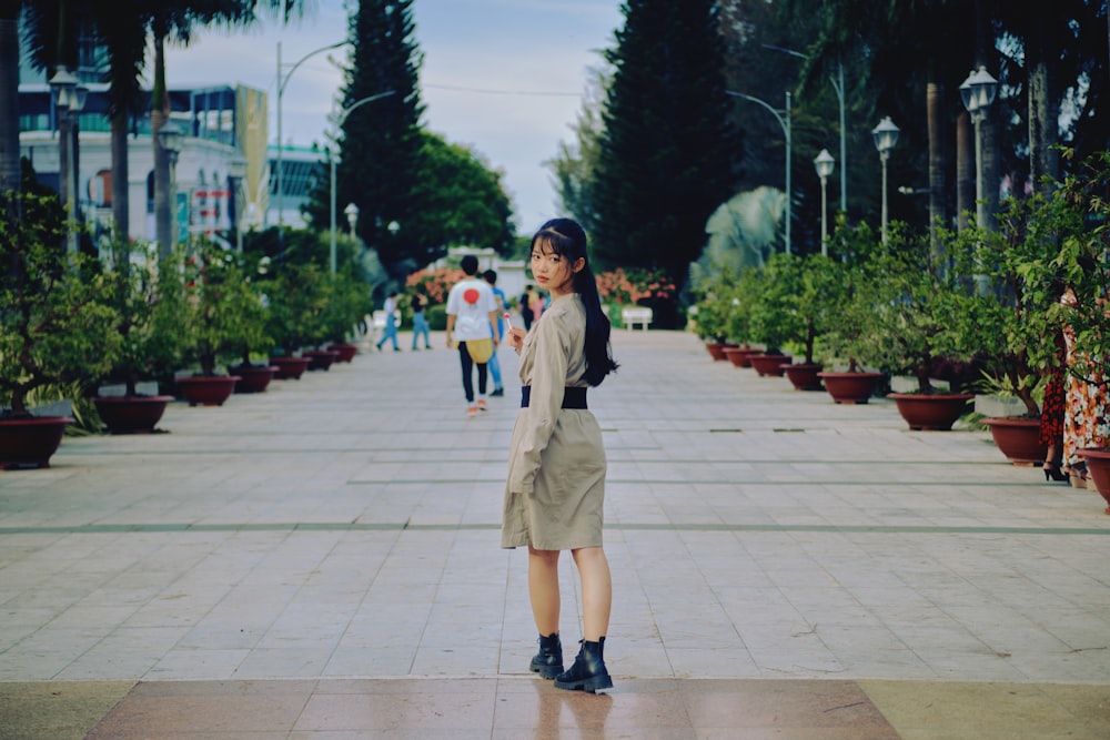 man and woman standing on gray concrete pavement during daytime