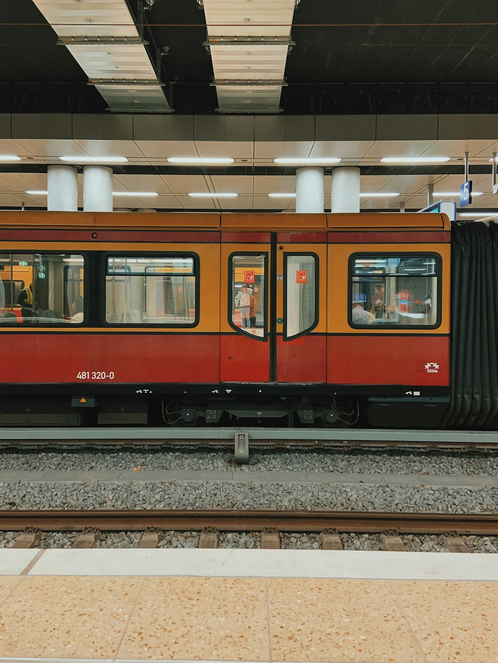 white and red train in train station