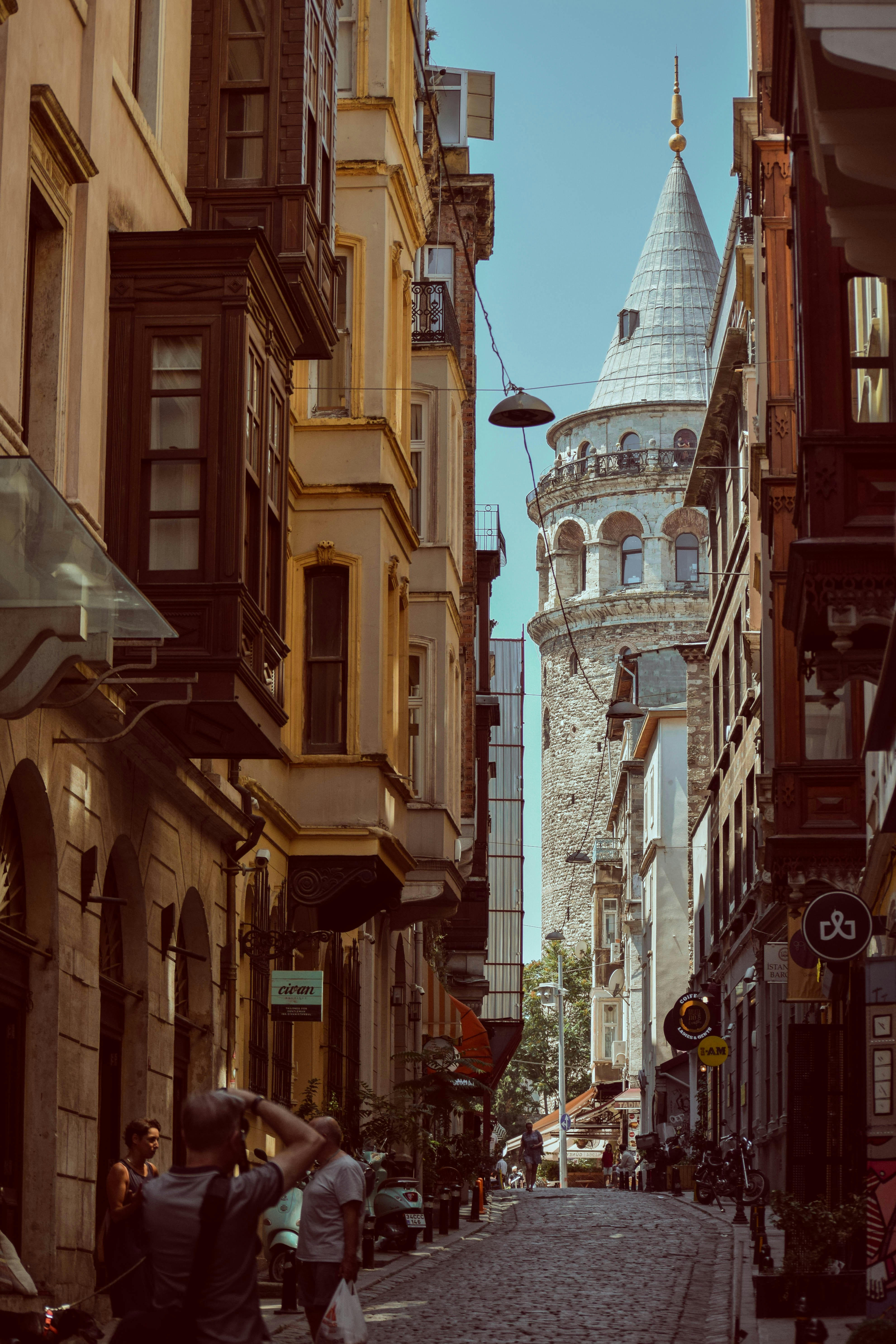 cars parked beside brown concrete building during daytime