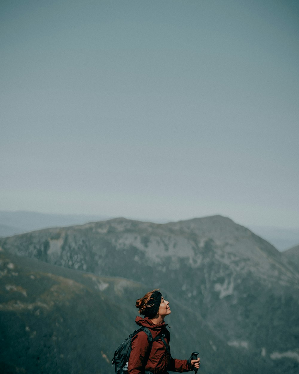 man in black jacket and black backpack standing on mountain during daytime