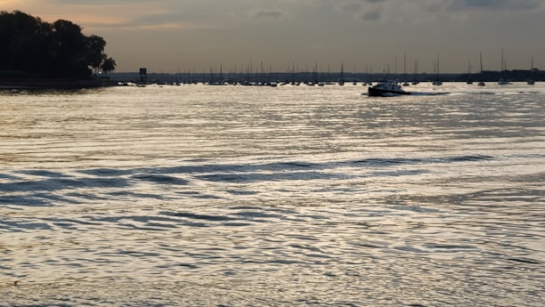 A serene marine scene digitally illustrated with gentle waves and a moored boat.