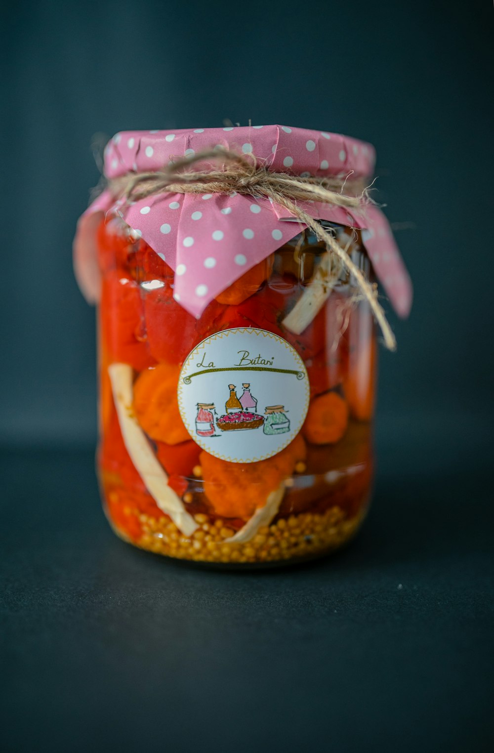 clear glass jar with red liquid inside