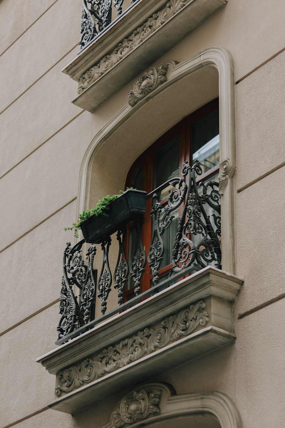 black metal window grill on white concrete building