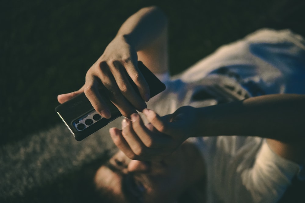 person holding iphone with black case