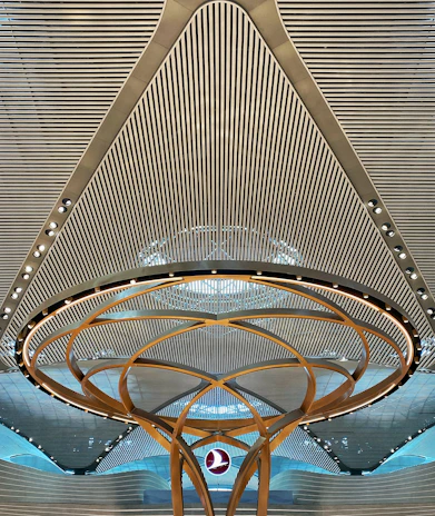Wide-angle view of a modern ceiling installation featuring clean lines and matte gold accents in a corporate office space.