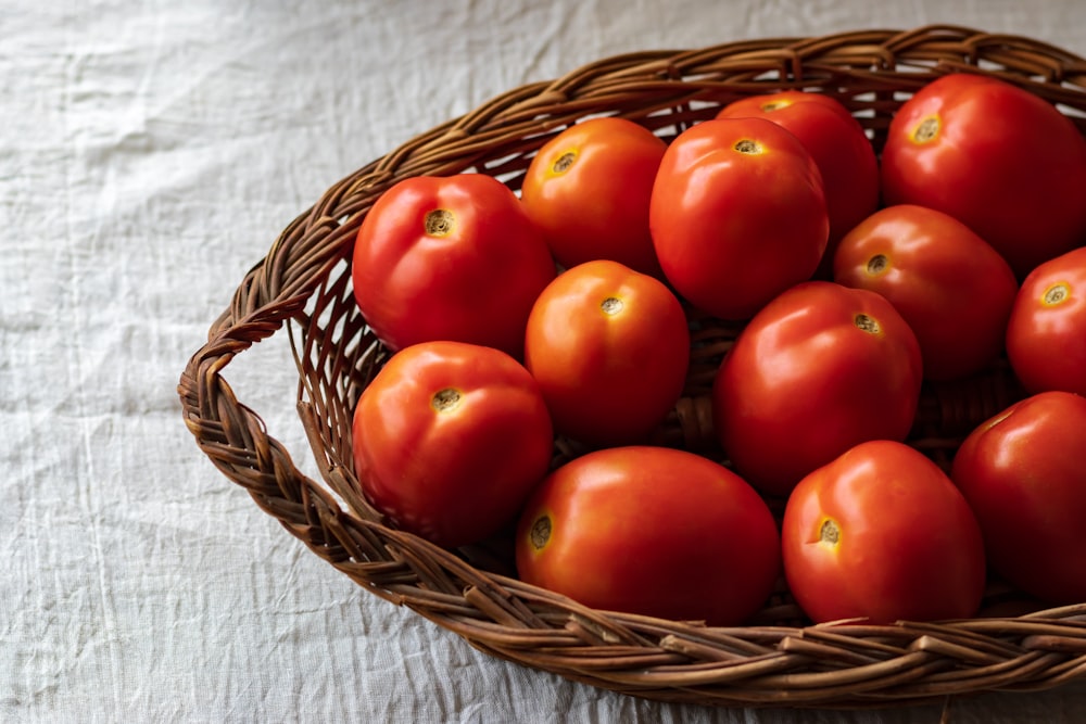 red tomatoes on brown woven basket