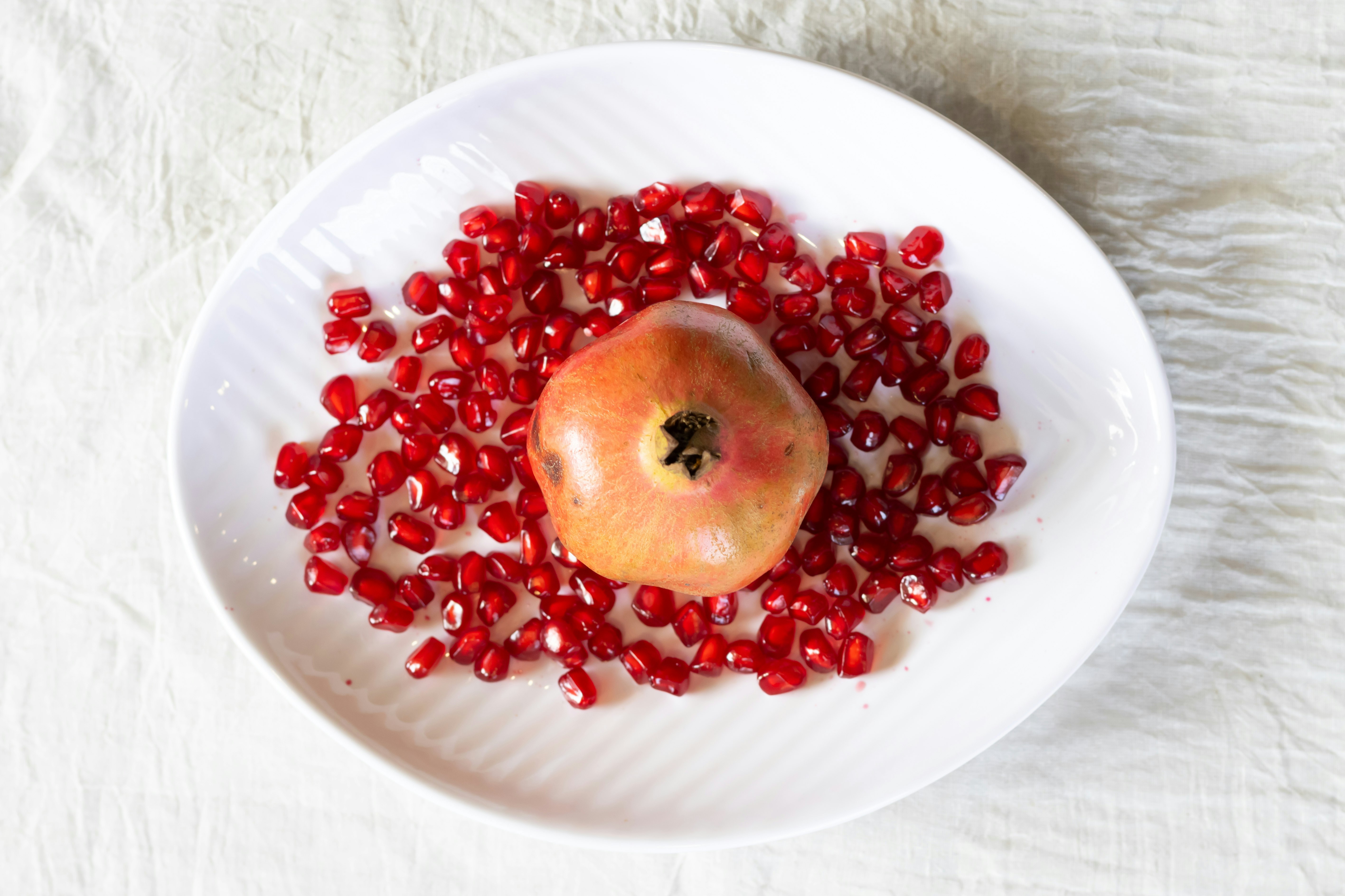 red round fruit on white ceramic plate