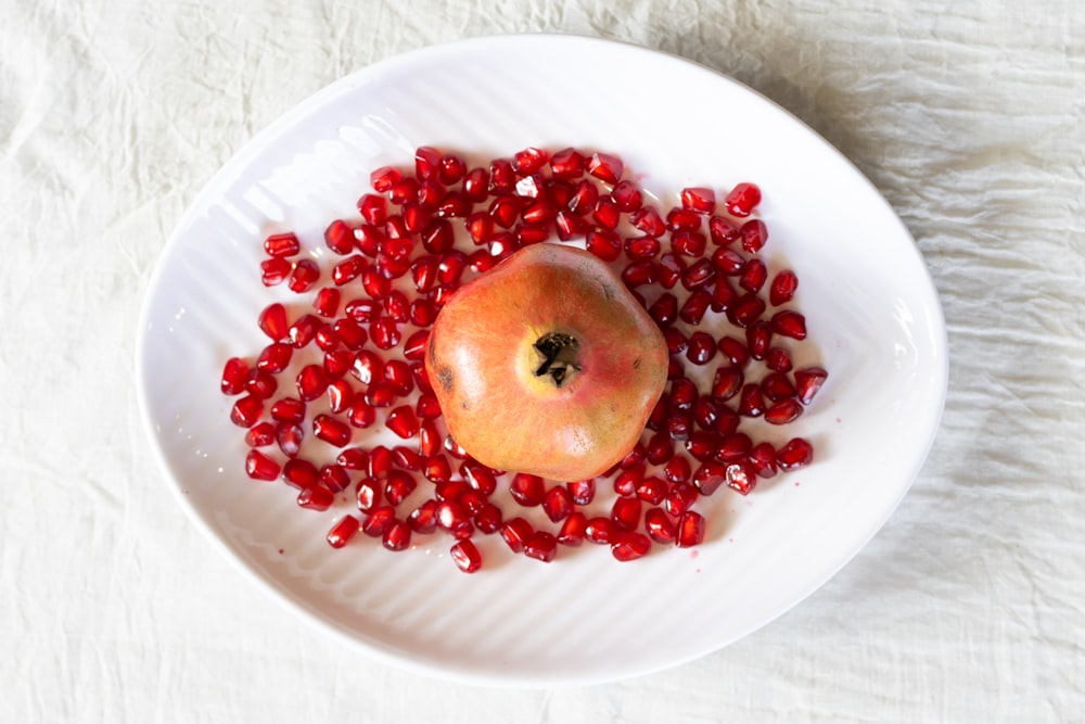 red round fruit on white ceramic plate