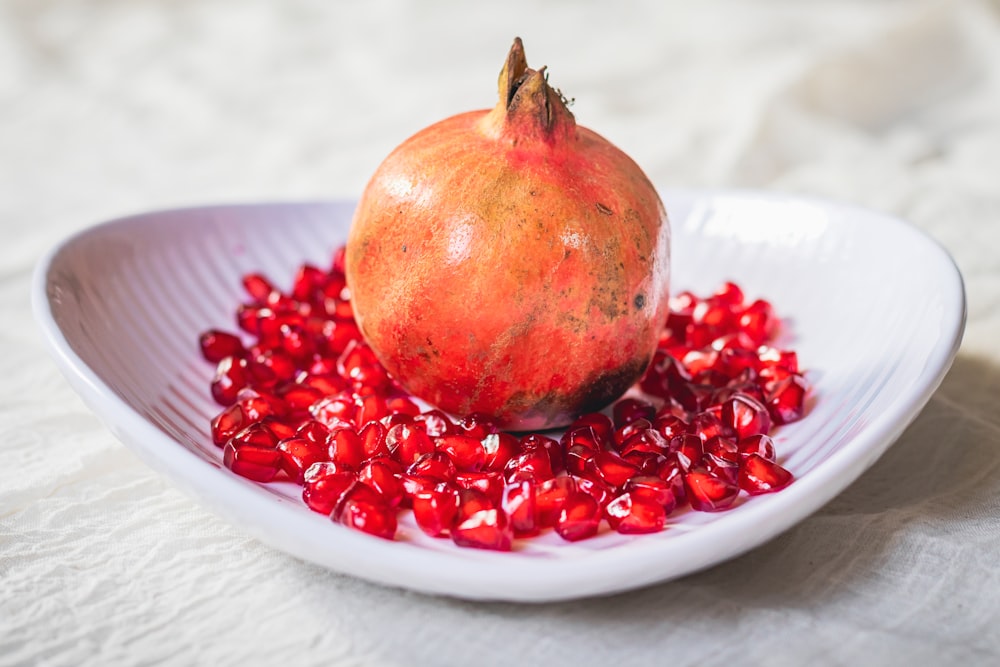 red fruit on white table cloth