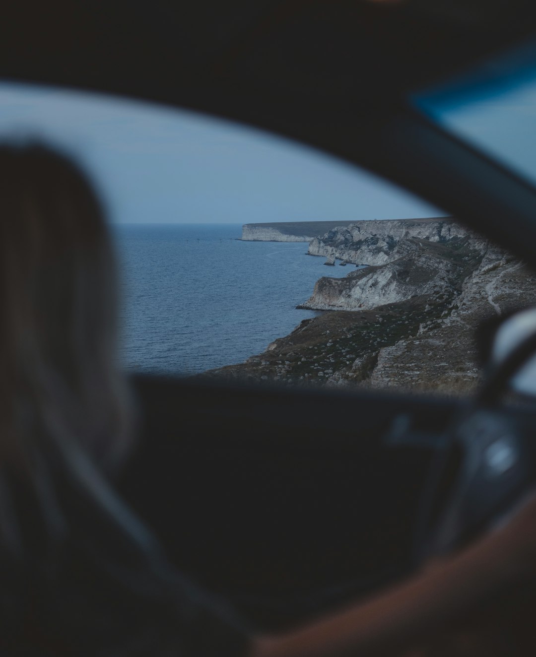 woman in black sunglasses sitting on car