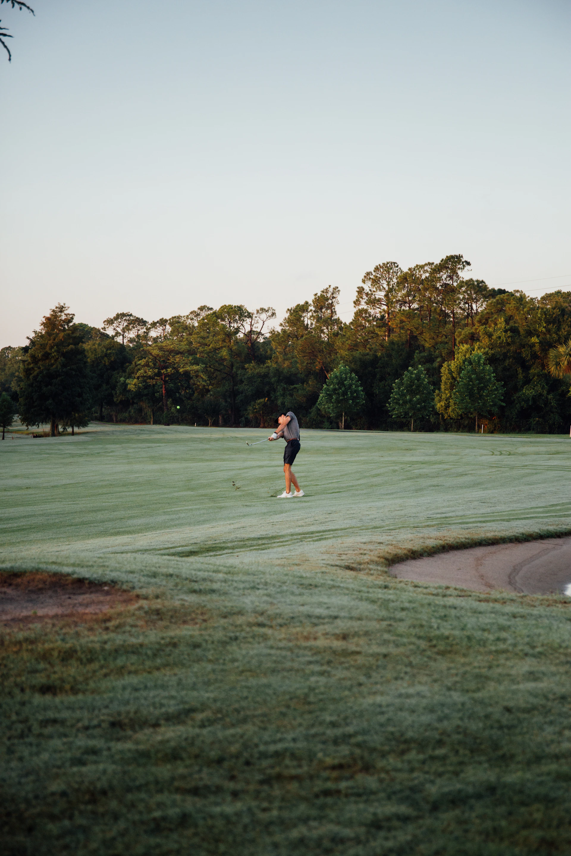 a man is playing golf on a golf course