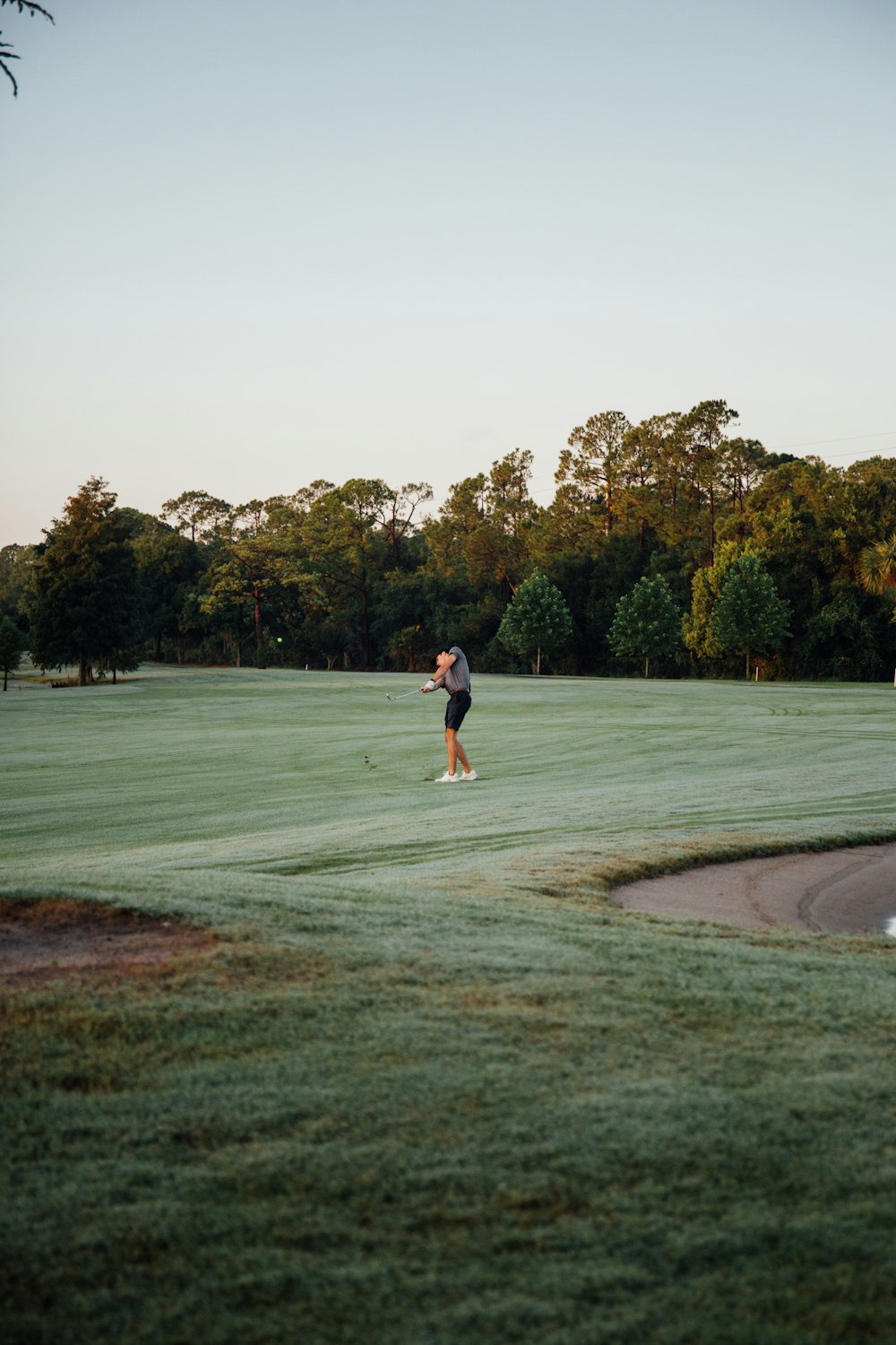 a man is playing golf on a golf course