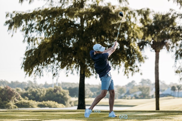 A golfer celebrating a great shot with fist raised, surrounded by cheering friends.