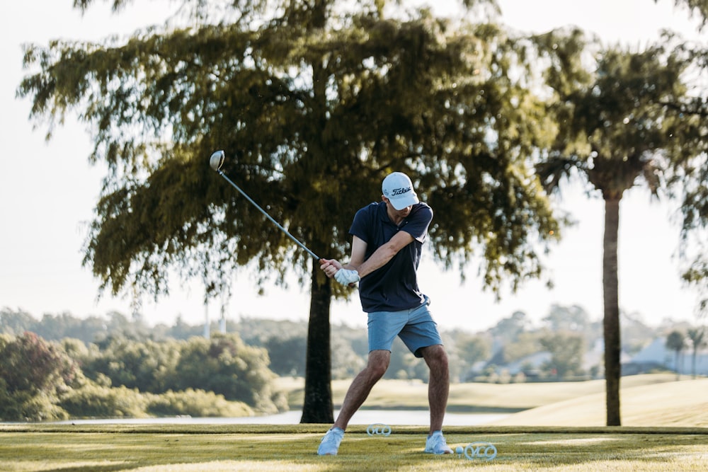 a man swinging a golf club on a golf course