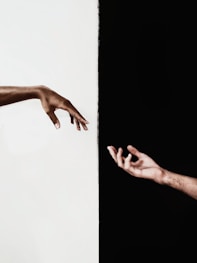 persons hand on white surface