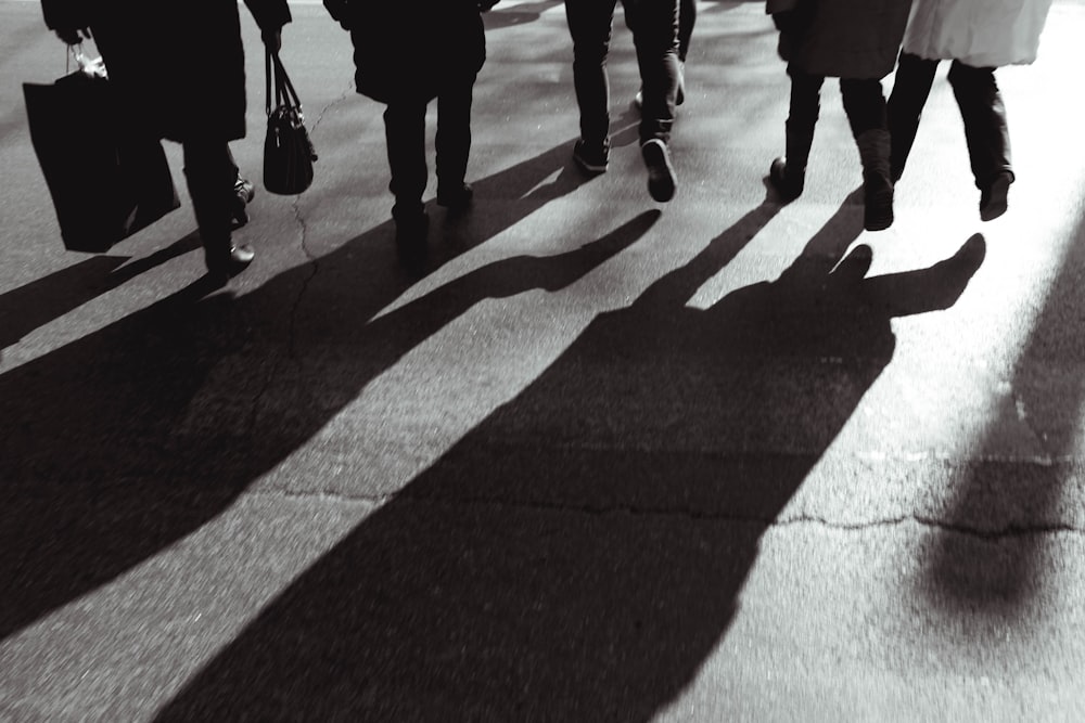 people walking on gray concrete pavement during daytime
