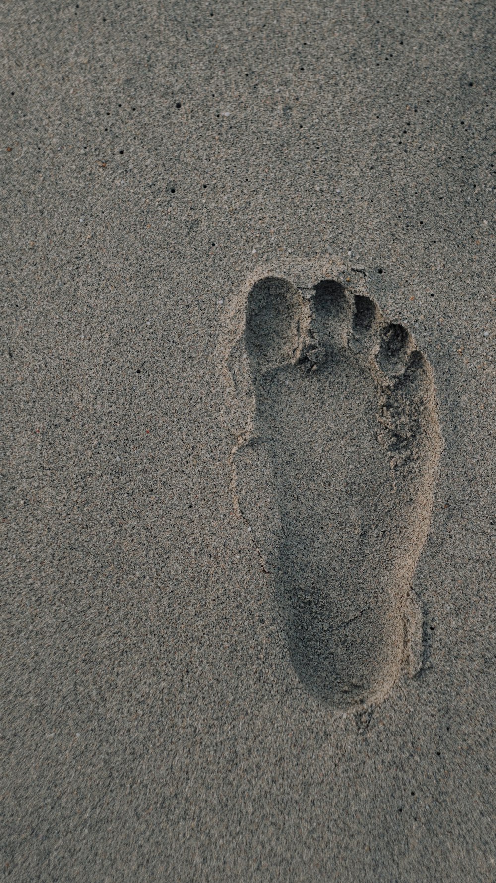 foot prints on brown sand