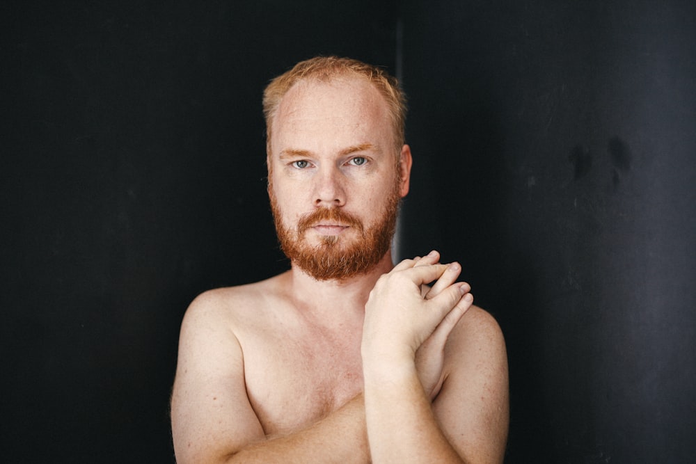 topless man with black background