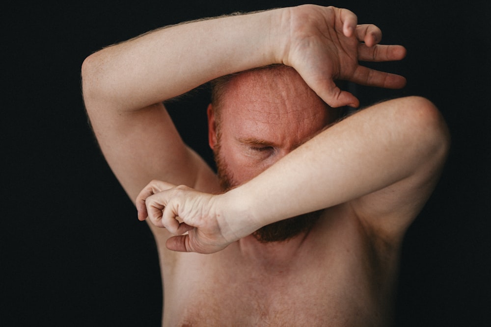 topless man with white powder on his face