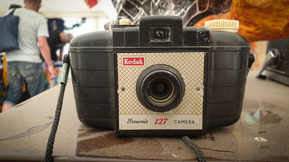 black and silver camera on brown table